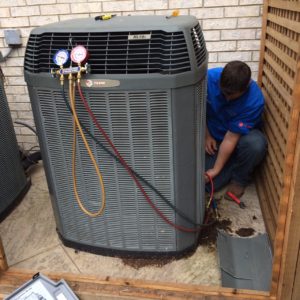 HVAC technician fixing outdoor AC unit
