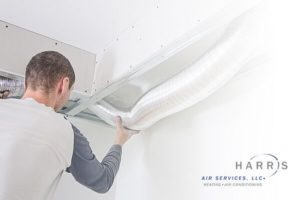 Technician performing air duct cleaning.