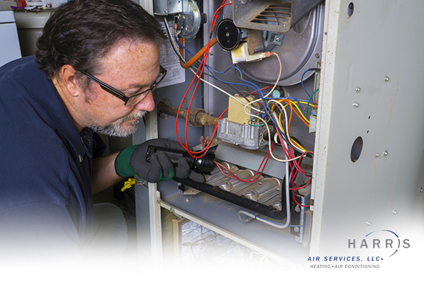 Technician performing maintenance on an HVAC system.