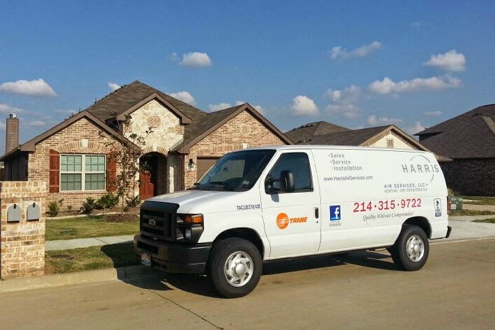Harris Air Services work van parked outside of a house