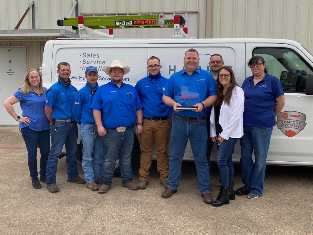 Harris Air Services team stands in front of truck.