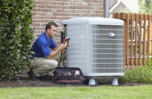 Harris Air technician inspects air conditioning unit outside a brick home