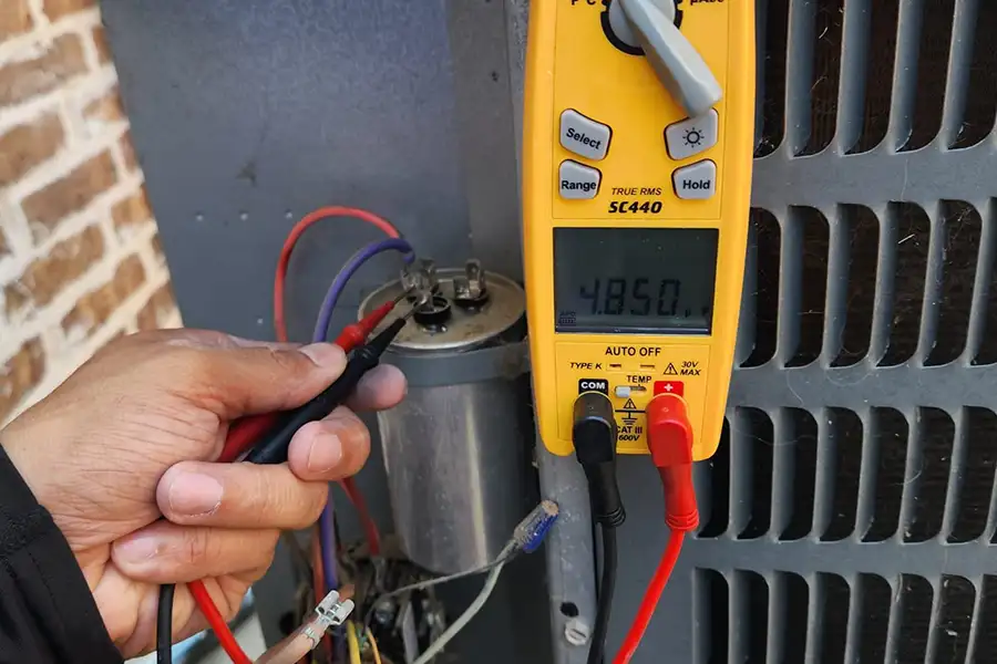 Technician performing heat pump maintenance in Mckinney