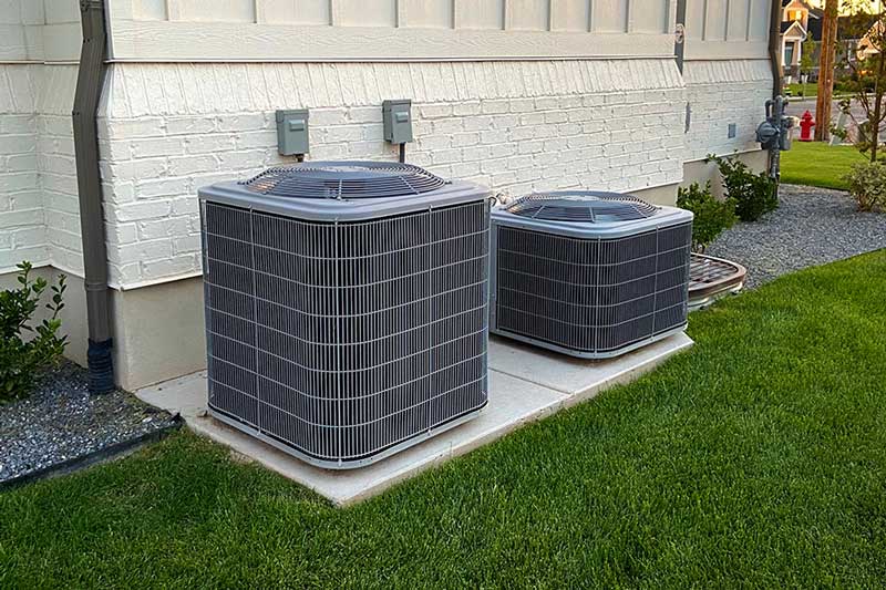 Two outdoor AC units installed on concrete pads in McKinney, TX