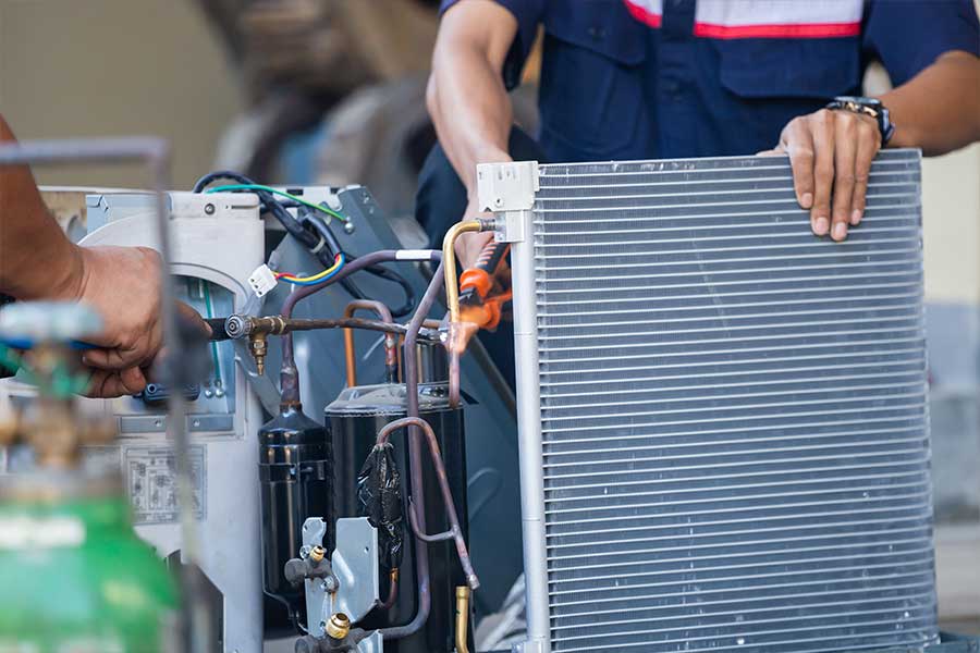 Technician servicing an indoor AC coil during HVAC repair in McKinney, TX